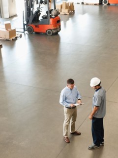 Workers talking in warehouse.