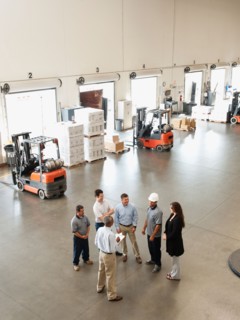 Workers talking in warehouse.