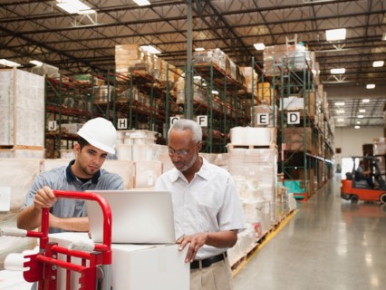Men working in warehouse.