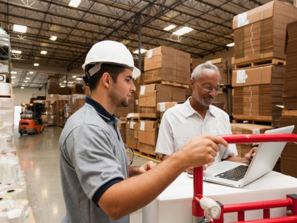 Men working in warehouse.