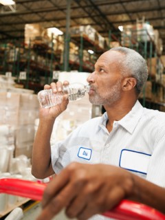 Warehouse worker drinking water.