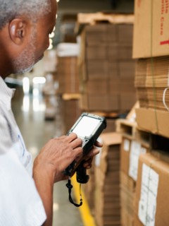Warehouse worker scanning delivery.
