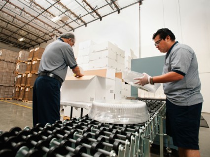 Warehouse workers assembling merchandise.