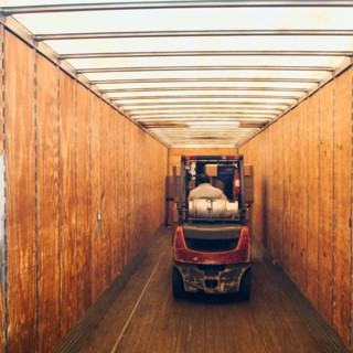 Forklift truck inside trailer.