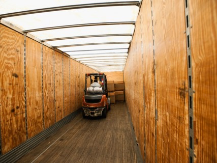 Forklift truck inside trailer.