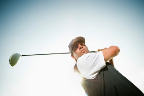 Low angle view of man playing golf.