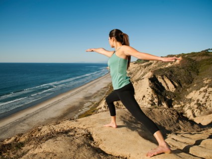USA, California, San Diego, Woman practicing yoga on beach.