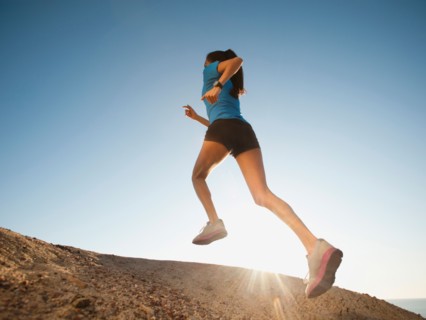 USA, California, San Diego, Woman jogging along sea coast.
