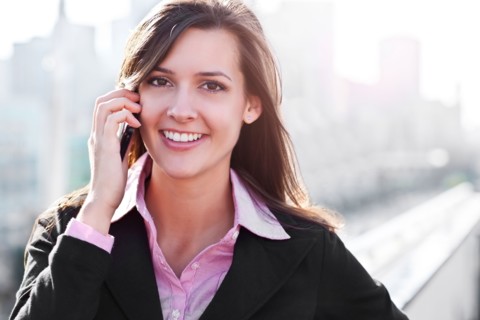 Smiling young businesswoman talking via mobile. Photo : Take A Pix Media