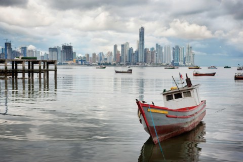 Panama, Panama City, Fishing boat with skyline in background. Photo : DreamPictures