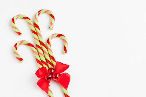 Striped candy canes with red ribbon, studio shot. Photo : Sarah M. Golonka