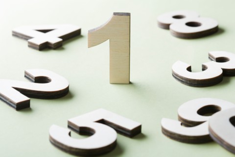 Numbers on white background, studio shot. Photo : Kristin Lee