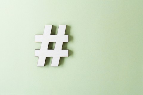 Hashtag on white background, studio shot. Photo : Kristin Lee