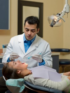 Dentist and patient in dental surgery. Photo : Dan Bannister