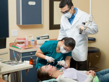 Dentists and patient in dental surgery. Photo : Dan Bannister
