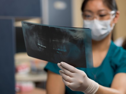 Dentist checking x-ray image. Photo : Dan Bannister