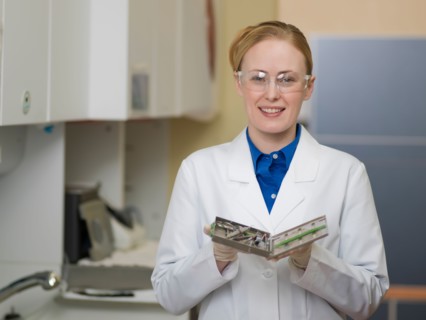 Portrait of dentist holding dental tools. Photo : Dan Bannister