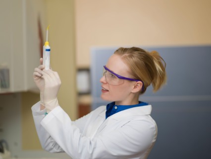 Portrait of dentist holding dental tools. Photo : Dan Bannister