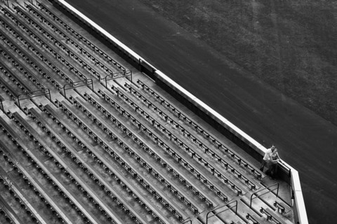 Distant view of couple and stadium bleachers. Photo : King Lawrence