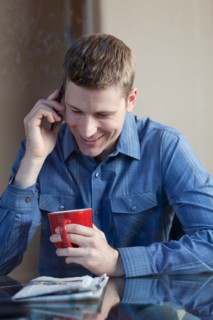 Man drinking coffee and talking on phone. Photo : db2stock