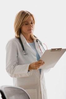 Doctor reading document. Photo : Rob Lewine