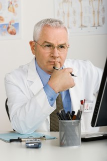 Doctor working on computer. Photo : Rob Lewine