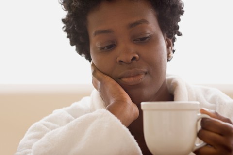 Woman enjoying cup of tea. Photo : Rob Lewine