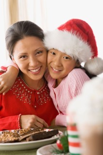 Portrait of mother and daughter enjoying christmas meal. Photo : Rob Lewine