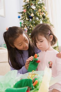 Two sisters (10-11) near Christmas tree. Photo : Rob Lewine