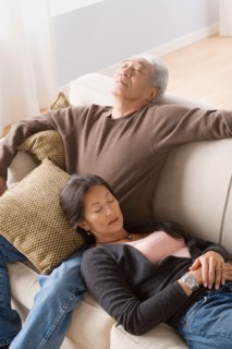 Portrait of couple resting on sofa. Photo : Rob Lewine
