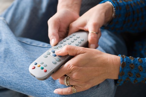 Couple fighting for remote control. Photo : Rob Lewine