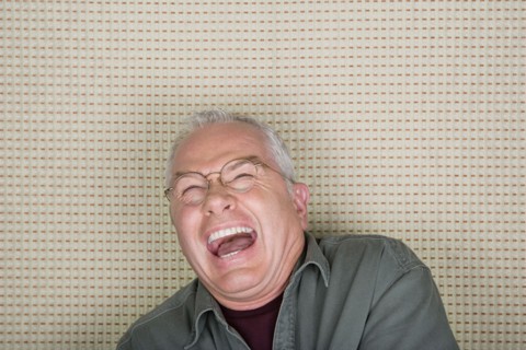 Studio portrait of senior man laughing. Photo : Rob Lewine