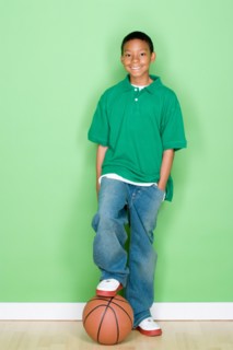 Studio portrait of teenage boy with basketball. Photo : Rob Lewine