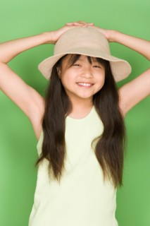 Studio shot portrait of teenage girl with hat, waist up. Photo : Rob Lewine