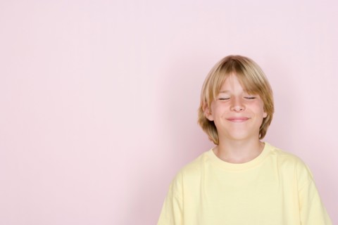 Studio shot portrait of teenage boy with eyes closed, head and shoulders. Photo : Rob Lewine