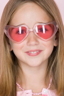 Studio shot portrait of teenage girl in pink sunglasses, close-up. Photo : Rob Lewine
