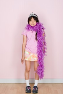 Studio shot portrait of teenage girl in diadem and feather boa shawl, full length. Photo : Rob