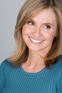 Studio shot portrait of mature woman looking away, head and shoulders. Photo : Rob Lewine