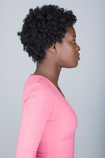 Studio shot portrait of mid adult woman, side view. Photo : Rob Lewine