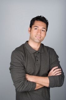 Studio shot portrait of mid adult man with arms crossed, waist up. Photo : Rob Lewine