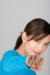Studio portrait of playful Asian woman. Photo : Rob Lewine