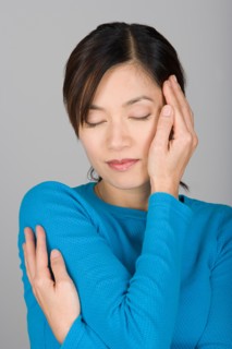 Studio shot of Vietnamese woman day dreaming. Photo : Rob Lewine