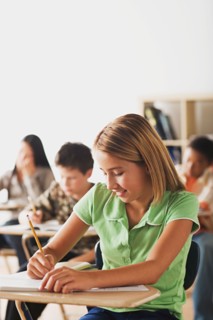 School kid writing in their copybooks. Photo : Rob Lewine