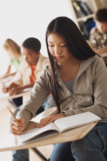 Class writing in their copy books. Photo : Rob Lewine