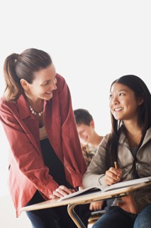 Teacher checking girl's homework. Photo : Rob Lewine