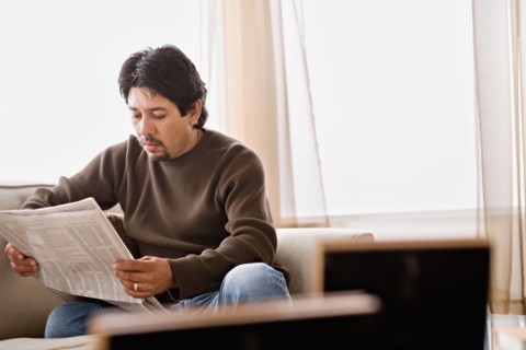 Mature man reading newspaper. Photo : Rob Lewine