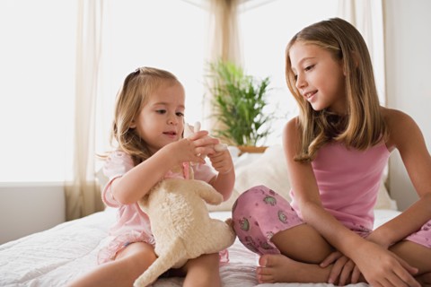 Two sisters playing together. Photo : Rob Lewine