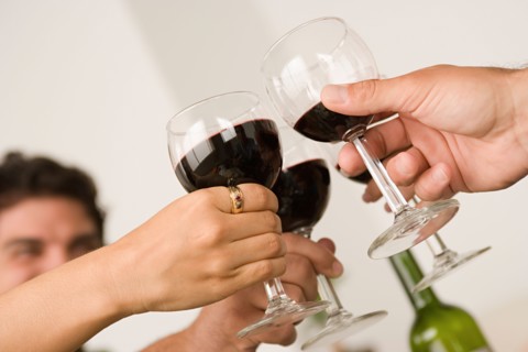 Hands holding wineglasses during toast . Photo : Rob Lewine