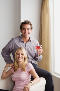 Portrait of smiling couple at home party. Photo : Rob Lewine
