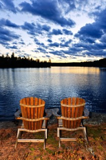 Canada, Ontario, Algonquin Park, Adirondack chairs on edge of lake. Photo :  Elena Elisseeva
